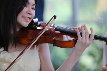 young woman musician playing fiddle violin music instrument, classical violinist person player