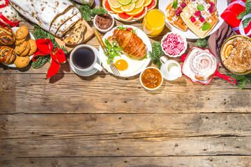 Festive Christmas morning breakfast or brunch table, with traditional foods – pancakes, Belgian...
