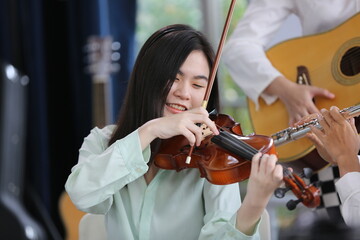 young woman musician playing fiddle violin music instrument, classical violinist person player