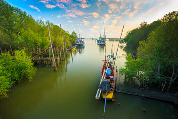 Fishing Boat Anchored among Mangrove Forest  - obrazy, fototapety, plakaty