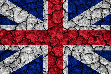 Flag of the United Kingdom over cracked background, conceptual image of crisis