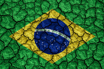 Brazil flag pattern on the crack soil texture. Retro vintage style. 