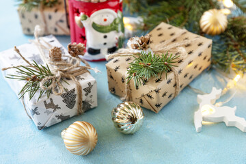 Holiday Xmas concept. Christmas card with fir tree, christmas lights and decor on a blue stone background.