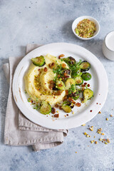 Brussels sprouts with pistachios, raisins and Skordalia (mashed potatoes). Healthy Meal preparation. Plant-based dishes. Green living. Vegan recipe. Food styling. Vegetarian cuisine