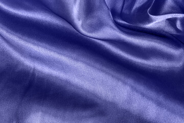 Fototapeta premium Color of the year 2022 elegant smooth silk or satin folds closeup. Cloth texture background. Abstract wallpaper. Trendy violet backdrop for web design. Luxury twisted fabric backplate