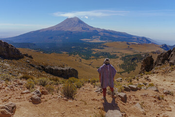 men Hiker Looking At Steaming Volcano