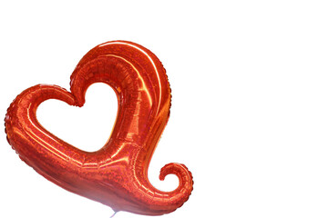 Red heart balloon with curly tail isolated on white background with room for copy.