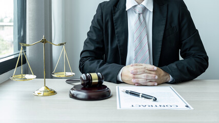 Male lawyer working with legal case document contract in office