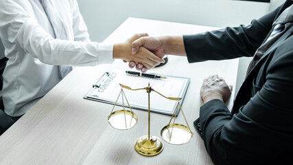 Male lawyer shaking hands with client after good deal negotiation cooperation meeting in courtroom