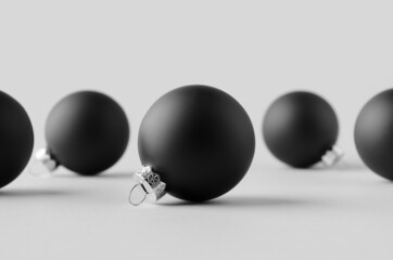 Multiple black matte Christmas balls mockup on a seamless grey background.