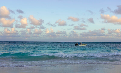 Small boat at the sea, pink clouds