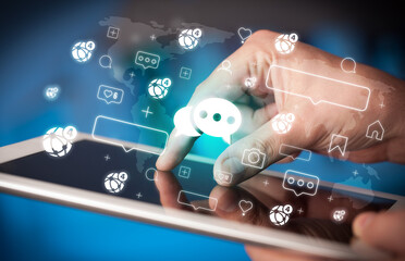 Close-up of a hand using tablet, social media concept