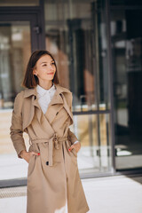 Young beautiful woman wearing coat walking in the city