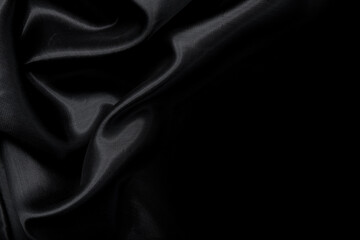 Part of the dark fabric texture of the fabric for the background and decoration of the work of art, a beautiful crumpled pattern of silk or linen. A crumpled piece of cloth