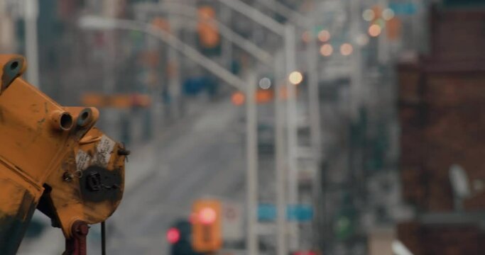 Closeup shot of a construction crane hinge over a city street in Toronto, Ontario.