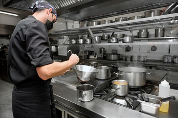 Chef cooking in modern industrial kitchen. High quality photo