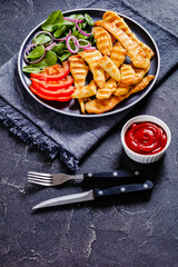grilled chicken strips on a plate with vegetables
