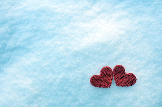 Valentine background with handmade hearts on snow. Happy lovers day card,