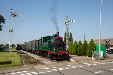 Steam train crossing junction and road in Dendermonde, Belgium