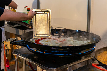 cook laying out the ingredients for the typical Spanish Paella