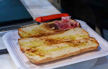 Iberian ham and olive oil toasts typical Spanish food.