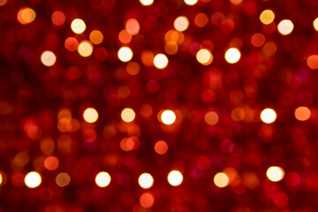 Festive red sparkling bokeh background with shiny sparkles and colorful dots as perfect background for Christmas, silvester, celebration and happy new year annotations as beautiful blurred glow