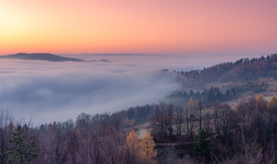 Misty autumn mountains landscape in the morning, Poland, Beskidy mountains seen from Koziarz peak.