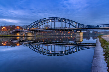 Pilsudski steel truss bridge over Vistula river in Krakow in the blue hour