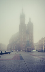Fototapeta na wymiar St Mary's church on Krakow Main Square in the thick fog, Poland.