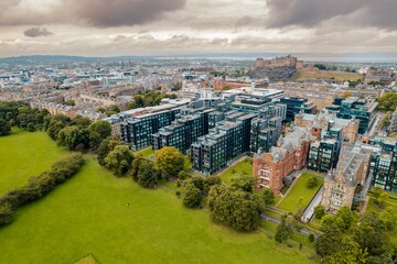 Obraz premium Edinburgh aerial top view. The neo-gothic structures of Edinburgh’s historic castle form silhouettes against the sky, providing a romantic view that has attracted visitors for years