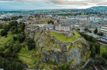 Aerial view of Edinburgh castle looms overlooking the Old Town. Edinburgh Castle is one of the most important and historic castles in Scotland. Edinburgh Castle has been Edinburgh's dominant landmark