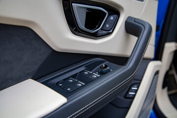 Obraz premium Interior of modern car. Side door buttons: window, mirror adjustment buttons, door lock. Car inside.