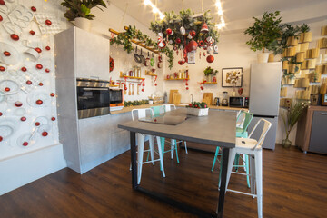 interior of a cozy modern spacious kitchen for a large family, decorated for the New Year celebration