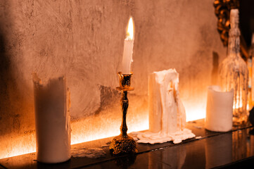 Witch candle burns in a beautiful interior for magic for halloween