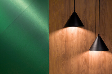 Two interior black lamps on a wooden wall indoors