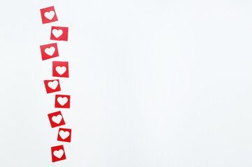 red squares with cut-out hearts on a white background with space for text