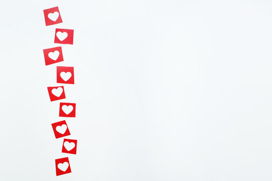 Red Squares With Cut-out Hearts On A White Background With Space For Text