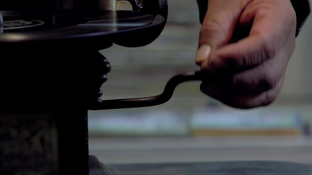 Man using a Hand Cranked Phonograph. Close Up. 4K Resolution.