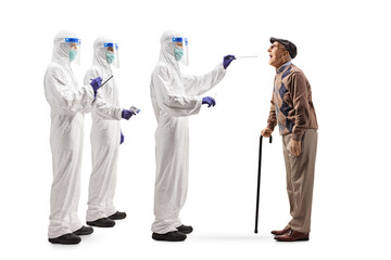 Full length profile shot of a team of healthcare workers taking a cotton swab test from an elderly...