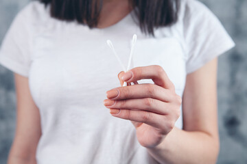 woman holding cotton swabs for ear