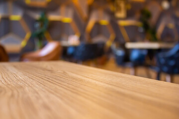 Wooden table in cafe with blur background.