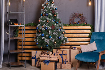 Stylish loft room interior with beautiful Christmas tree. dark blue and brown and gold colors. new years atmosphere decoration