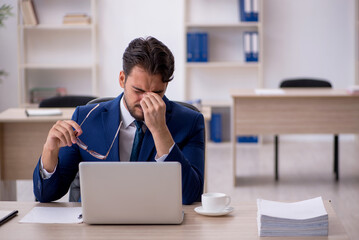 Young male employee working in the office