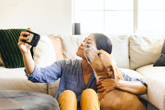 Woman Taking Selfie With Dog At Home