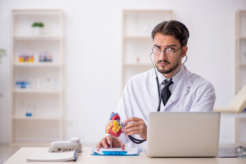Young male doctor cardiologist working in the clinic