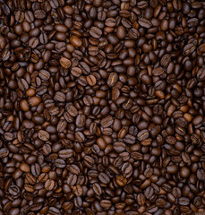 Background of coffee beans. Texture of roasted coffee beans. Coffee beans close up.