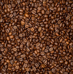 Background of coffee beans. Texture of roasted coffee beans. Coffee beans close up.