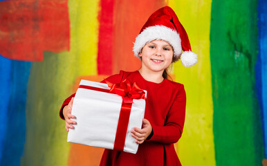 Winter holidays. Beautiful gift package. Give away. Merry Christmas and happy holidays. Little girl hold gift box. Kid hold present box colorful background. Xmas gift shopping. Family tradition