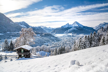 Idylic mountain hut above the snow-covered Berchtesgaden, Bavaria, Germany