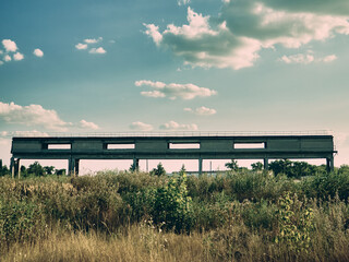 A strange concrete structure in the middle of a wasteland overgrown with wild grass, these are the...